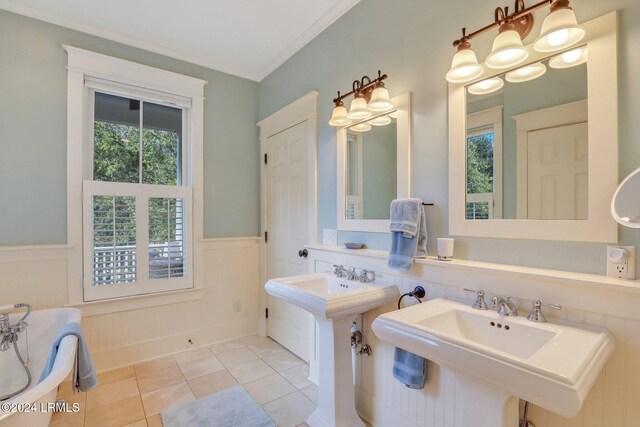 bathroom featuring tile patterned flooring, double sink, and crown molding