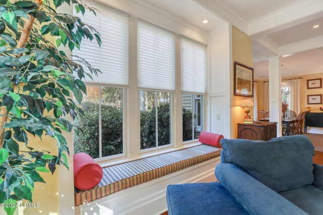 living room featuring ornamental molding and beam ceiling