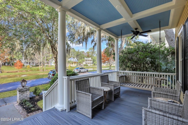 wooden deck featuring ceiling fan and covered porch