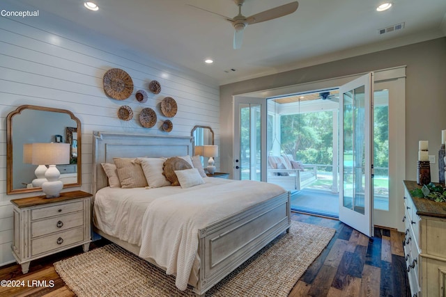 bedroom with dark hardwood / wood-style flooring, access to outside, ceiling fan, and wood walls