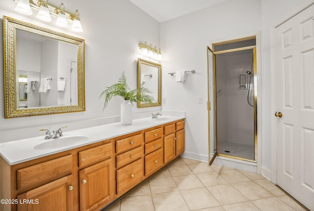 bathroom featuring a sink, double vanity, a shower stall, and tile patterned flooring