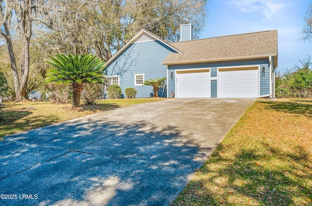 view of property exterior featuring driveway, a lawn, roof with shingles, and a chimney