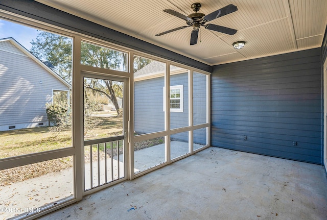 unfurnished sunroom featuring ceiling fan