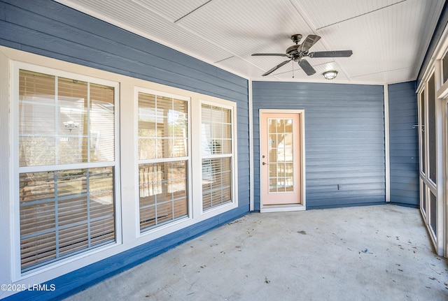 unfurnished sunroom with a ceiling fan