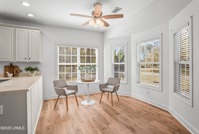 living area with recessed lighting, visible vents, a healthy amount of sunlight, and light wood-style flooring