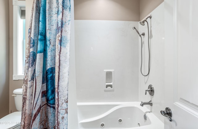 bathroom featuring toilet and a combined bath / shower with jetted tub