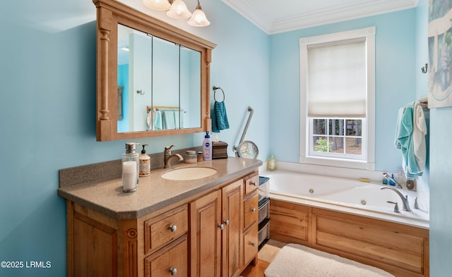 full bath featuring a tub with jets, vanity, and crown molding