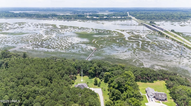 aerial view with a wooded view and a water view