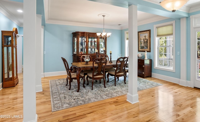 dining room featuring baseboards, an inviting chandelier, crown molding, and light wood finished floors