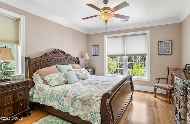 bedroom with baseboards, wood finished floors, visible vents, and ornamental molding