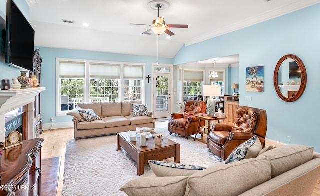 living room featuring wood finished floors, baseboards, a premium fireplace, lofted ceiling, and ornamental molding