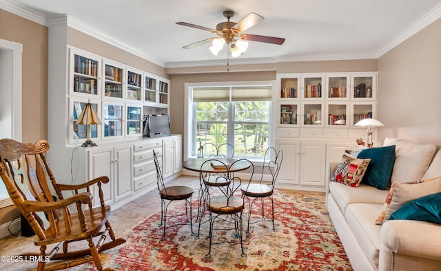 dining space with crown molding and ceiling fan