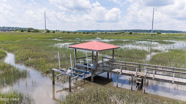 view of dock with boat lift and a water view