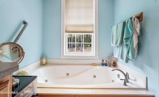 full bathroom featuring vanity and a tub with jets