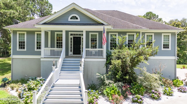 view of front of home featuring a porch, stairs, and a shingled roof