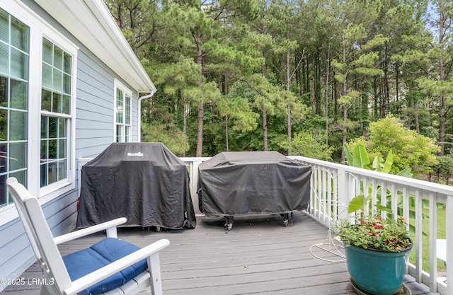 wooden deck with a grill