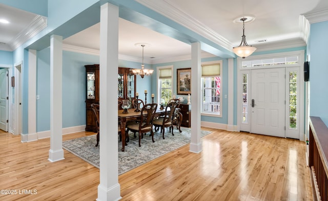 foyer featuring visible vents, baseboards, light wood-style flooring, an inviting chandelier, and ornate columns