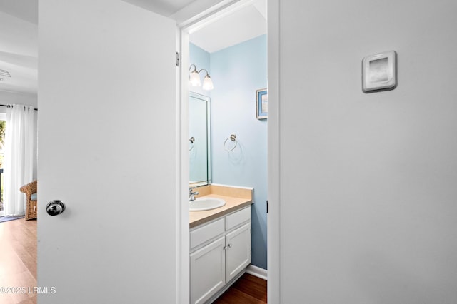 bathroom featuring wood finished floors and vanity