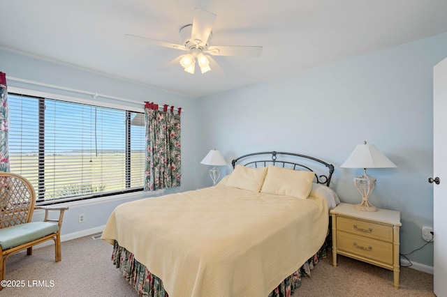 carpeted bedroom with baseboards and a ceiling fan