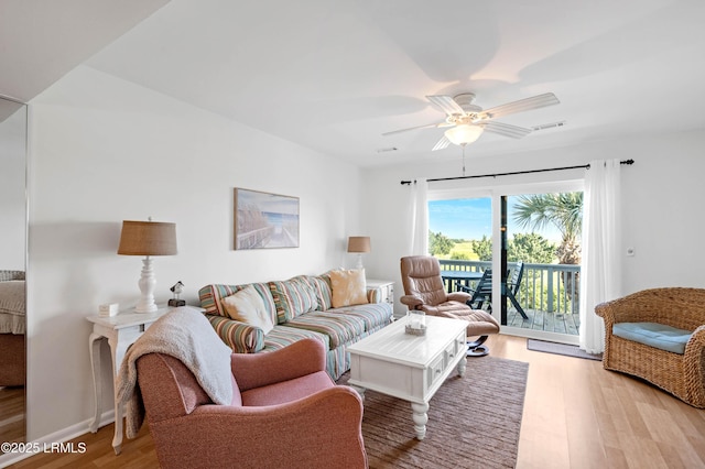living area with light wood-type flooring and ceiling fan