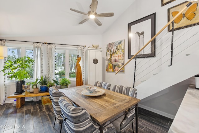 dining space featuring lofted ceiling, stairway, baseboards, and wood finish floors