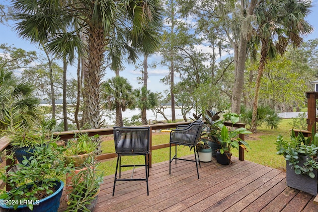 wooden deck with a lawn