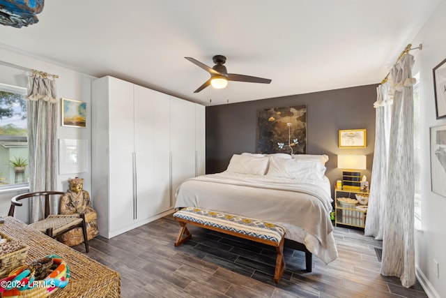 bedroom featuring baseboards, wood finished floors, and a ceiling fan