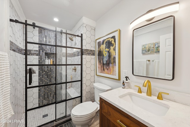 bathroom featuring a shower stall, toilet, and vanity