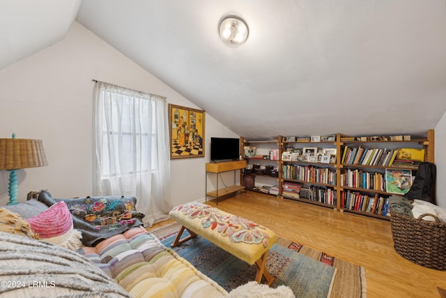 living room with hardwood / wood-style flooring and vaulted ceiling