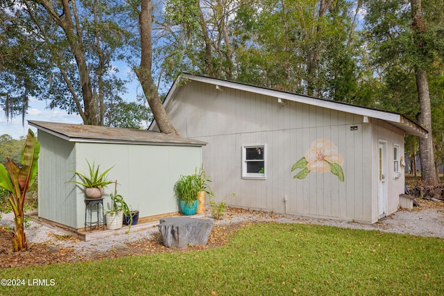 view of property exterior with a yard