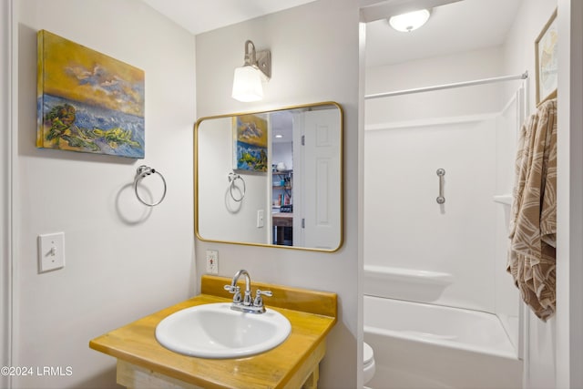 bathroom featuring toilet, shower / bath combination, and a sink