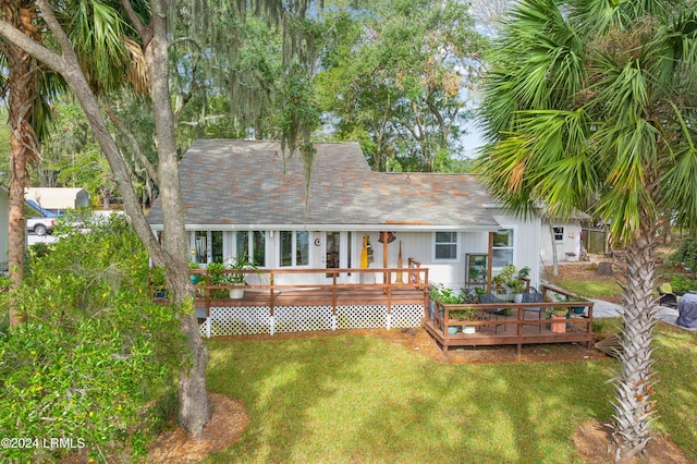 rear view of house with a deck and a lawn