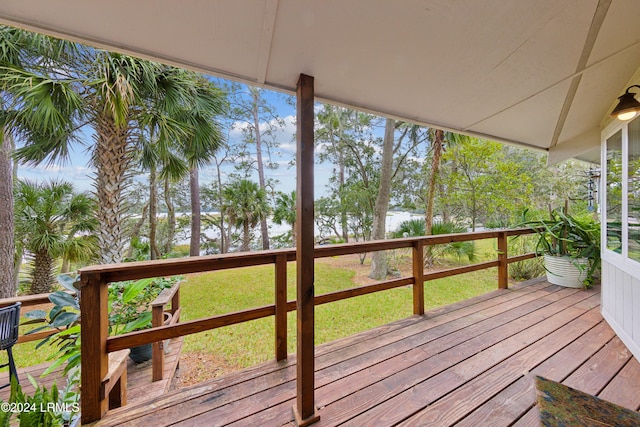 wooden terrace featuring a yard