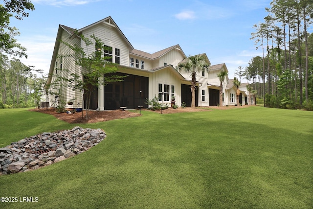 17 Marlowe Way Unit 1, Bluffton, SC 29910 - rear view of house with a lawn, board and batten siding, and a sunroom