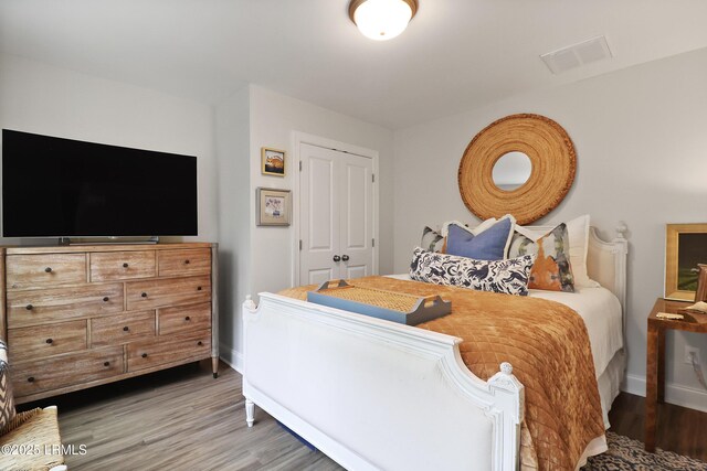 17 Marlowe Way Unit 1, Bluffton, SC 29910 - bedroom featuring baseboards, wood finished floors, and a closet