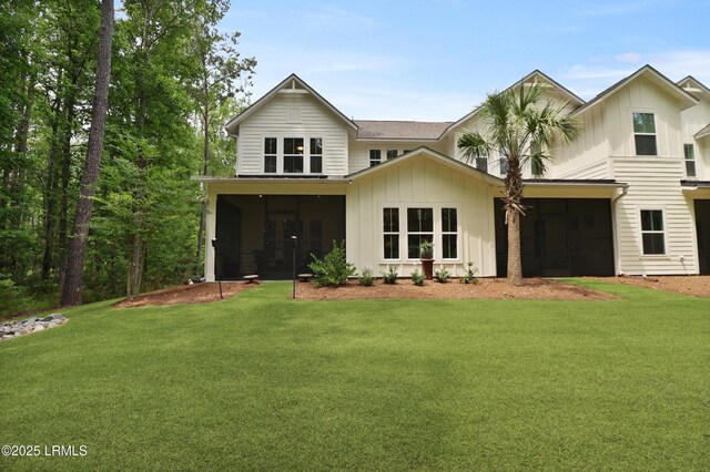 17 Marlowe Way Unit 1, Bluffton, SC 29910 - view of front of house with a sunroom, board and batten siding, and a front lawn