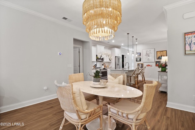 17 Marlowe Way Unit 1, Bluffton, SC 29910 - dining area with baseboards, a chandelier, ornamental molding, dark wood-style floors, and recessed lighting