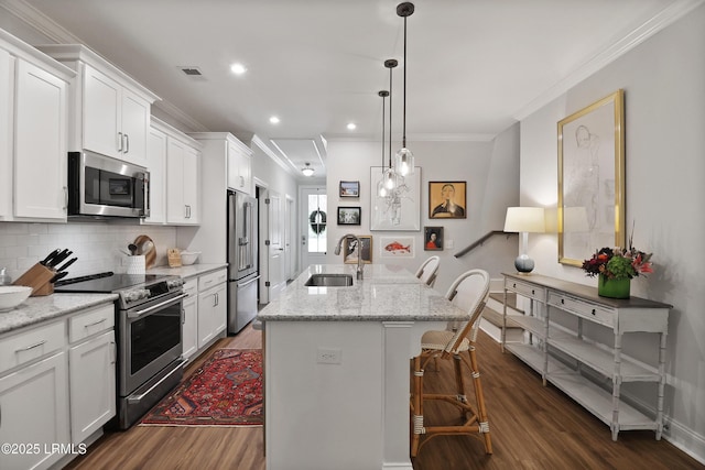 17 Marlowe Way Unit 1, Bluffton, SC 29910 - kitchen featuring appliances with stainless steel finishes, dark wood-style flooring, a sink, crown molding, and a kitchen island with sink