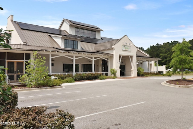 17 Marlowe Way Unit 1, Bluffton, SC 29910 - view of front of home with solar panels, uncovered parking, metal roof, and a standing seam roof