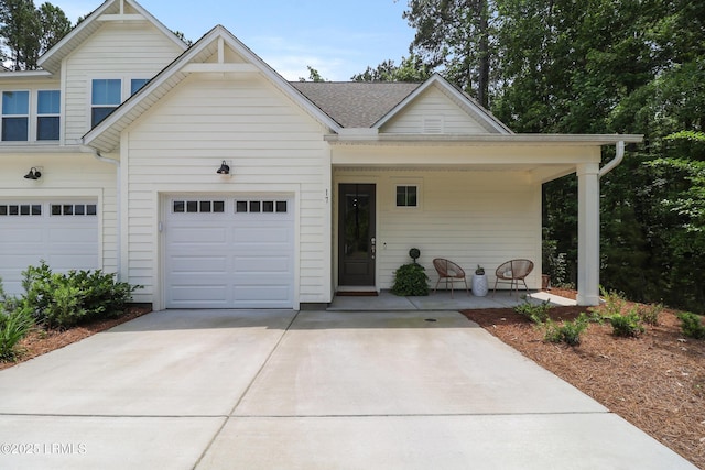 17 Marlowe Way Unit 1, Bluffton, SC 29910 - view of front of home featuring covered porch, concrete driveway, and a garage