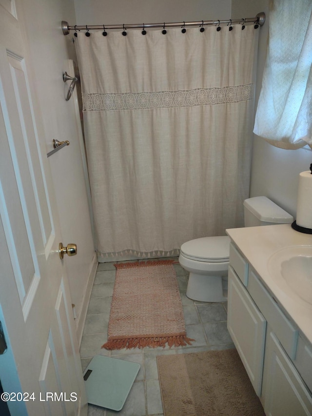 bathroom featuring vanity, tile patterned floors, and toilet