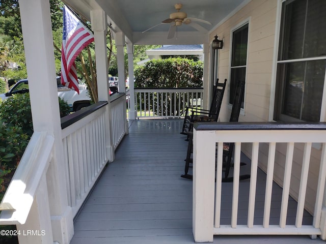 wooden deck with covered porch and ceiling fan