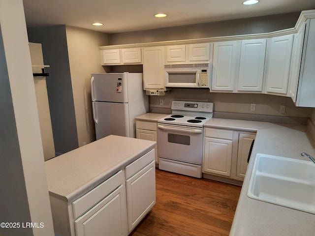 1317 Broad St, Beaufort, SC 29902 - kitchen featuring a sink, white appliances, white cabinetry, light countertops, and wood finished floors