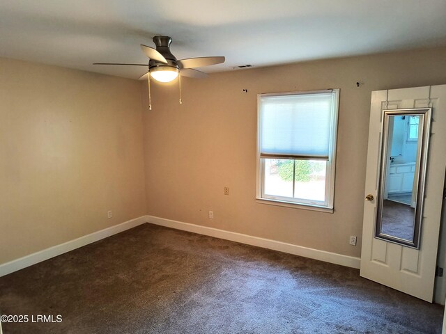1317 Broad St, Beaufort, SC 29902 - spare room with visible vents, ceiling fan, dark colored carpet, and baseboards
