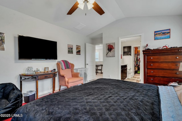 bedroom featuring lofted ceiling, ensuite bath, and ceiling fan