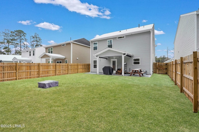 back of house featuring a yard and a patio