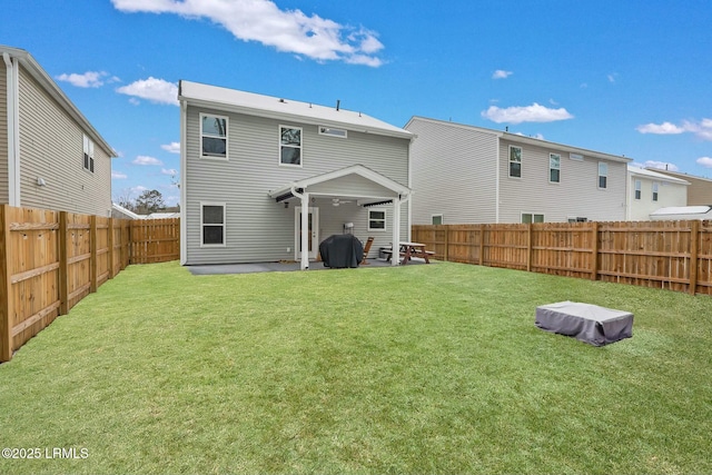 rear view of house with a yard and a patio area