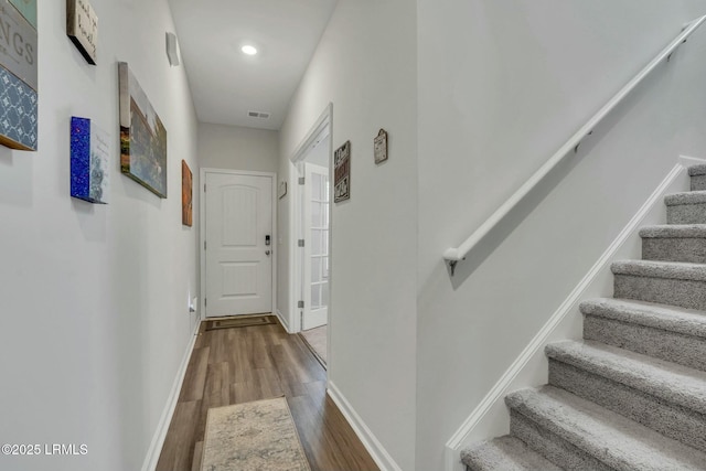 hall with wood-type flooring