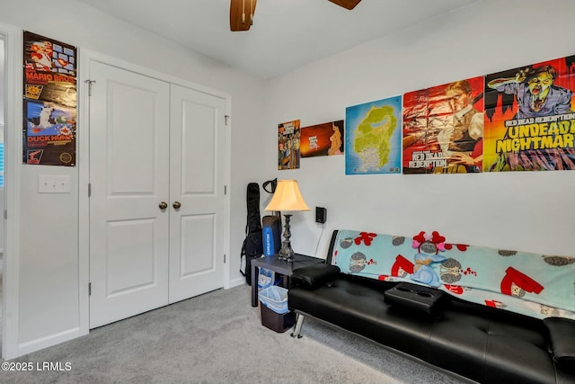 sitting room featuring ceiling fan and light carpet