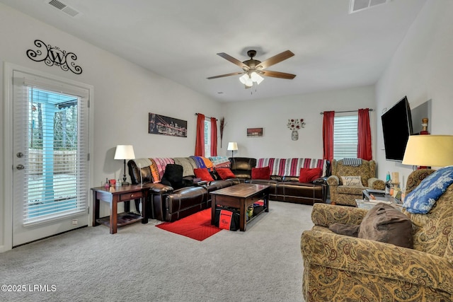 living room featuring carpet and ceiling fan